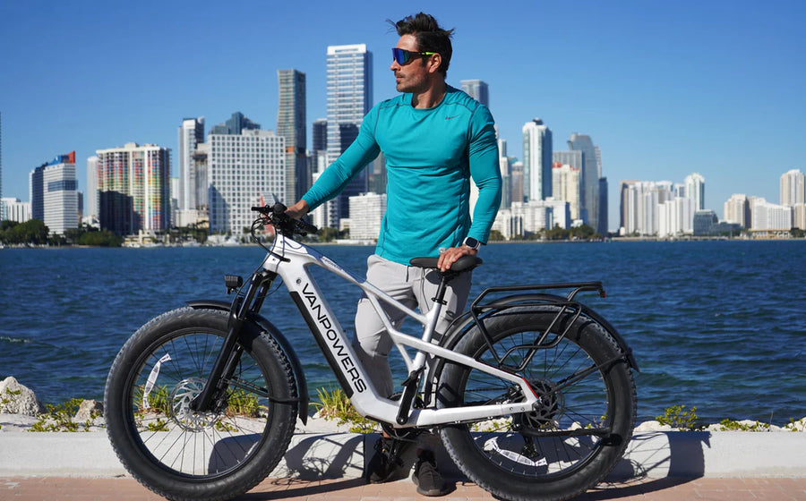 Rider with a white fat-tire e-bike on the waterfront